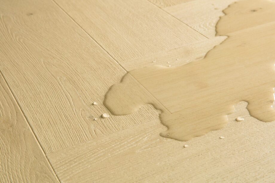 kalanruoto-laminaatti-quick-step-impressive-design-ginger-oak Kalanruoto laminaatti Quick Step Impressive Suunnittelu Ginger Oak, lämmin keskiruskea tammen sävy ja tasainen lajitelma, vesilätäkkö osoittamassa vedenkestävyyttä