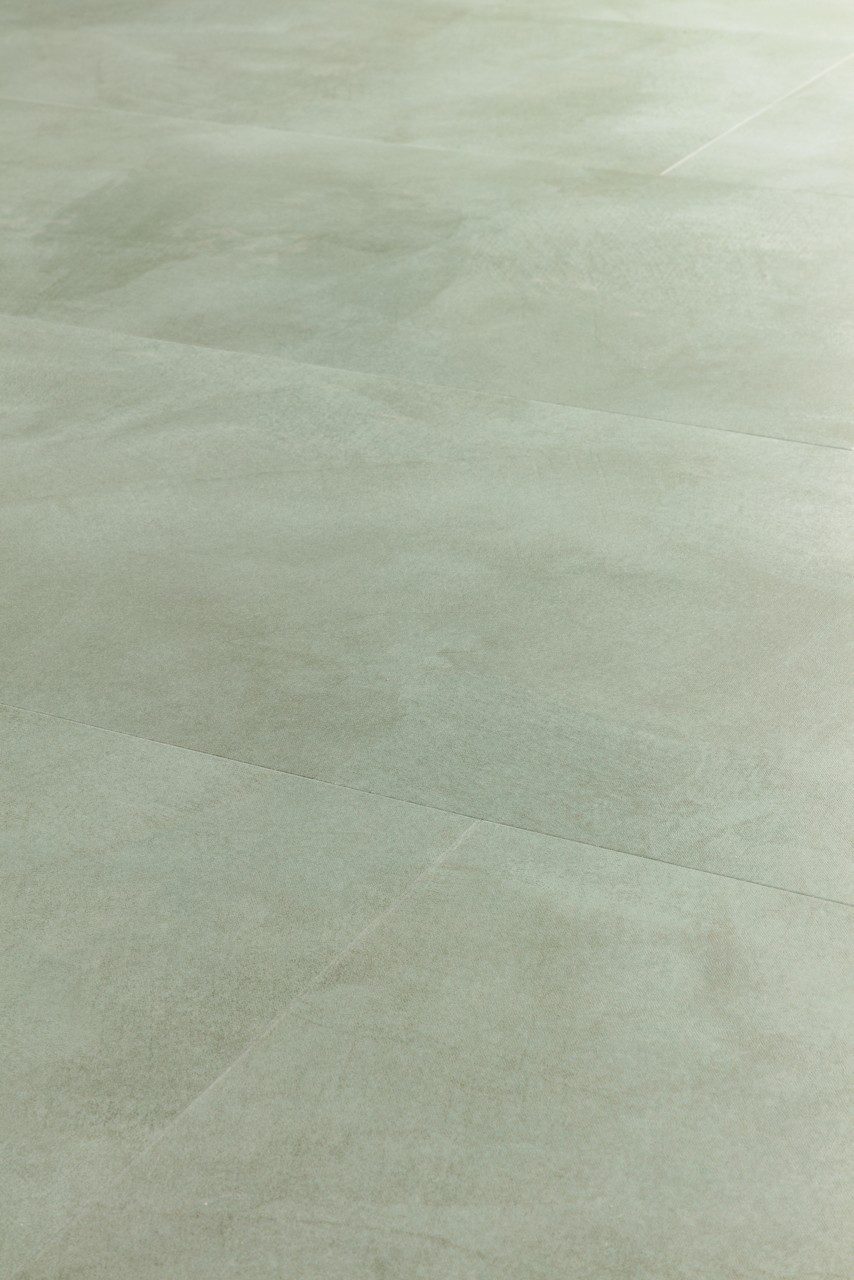 Vinüülparkett Quick-Step Illume Soft sage roheka tooni ja betooni disainiga.