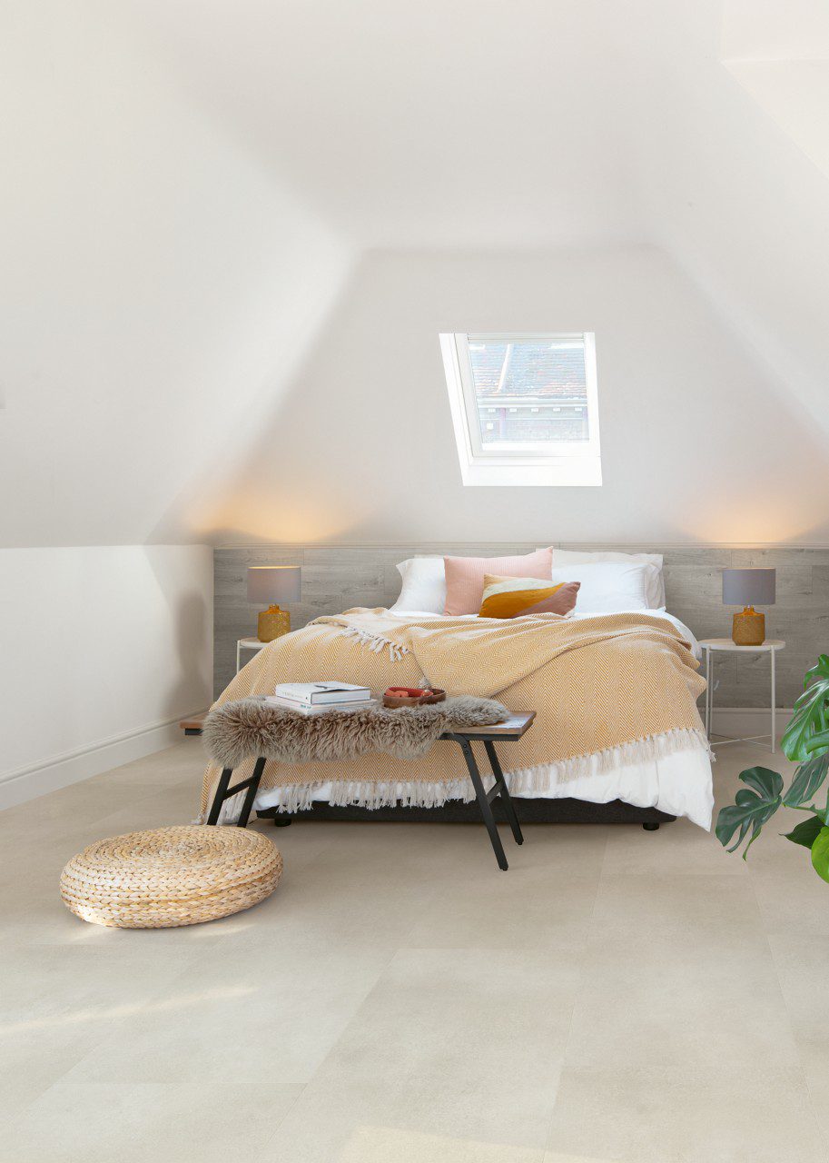 Vinyl tiles Quick-Step Illume Sandstone concrete installed on bedroom floor.