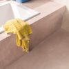 vinyl-flooring-tiles-quick-step-illume-soft-blush Vinyl flooring tiles Quick-Step Illume Soft blush installed on bathroom floor. Built in bath inside pink color structure same as flooring.