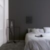 vinyl-flooring-tiles-quick-step-illume-soft-graphite Vinyl flooring tiles Quick-Step Illume Soft graphite with dark grey color installed on bedroom floor. King size bed.